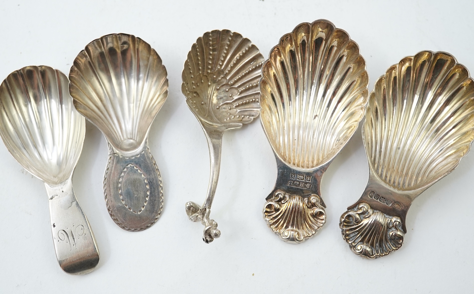 Ten assorted 19th and 20th century silver caddy spoons, with shell or fluted bowls